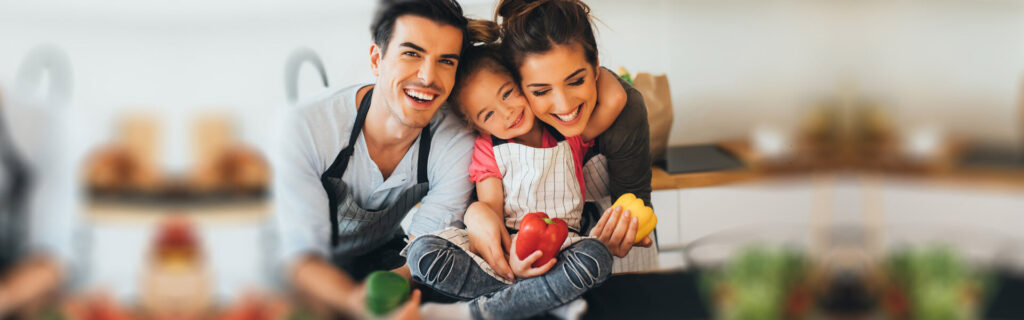 Happy family with fresh produce promoting a healthy lifestyle