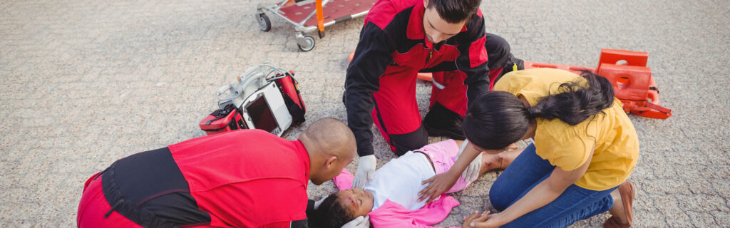 Emergency responders providing first aid to child on street